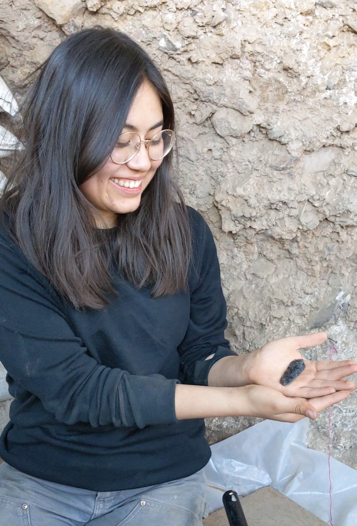 Museum field school student and an artifact she uncovered in 2019