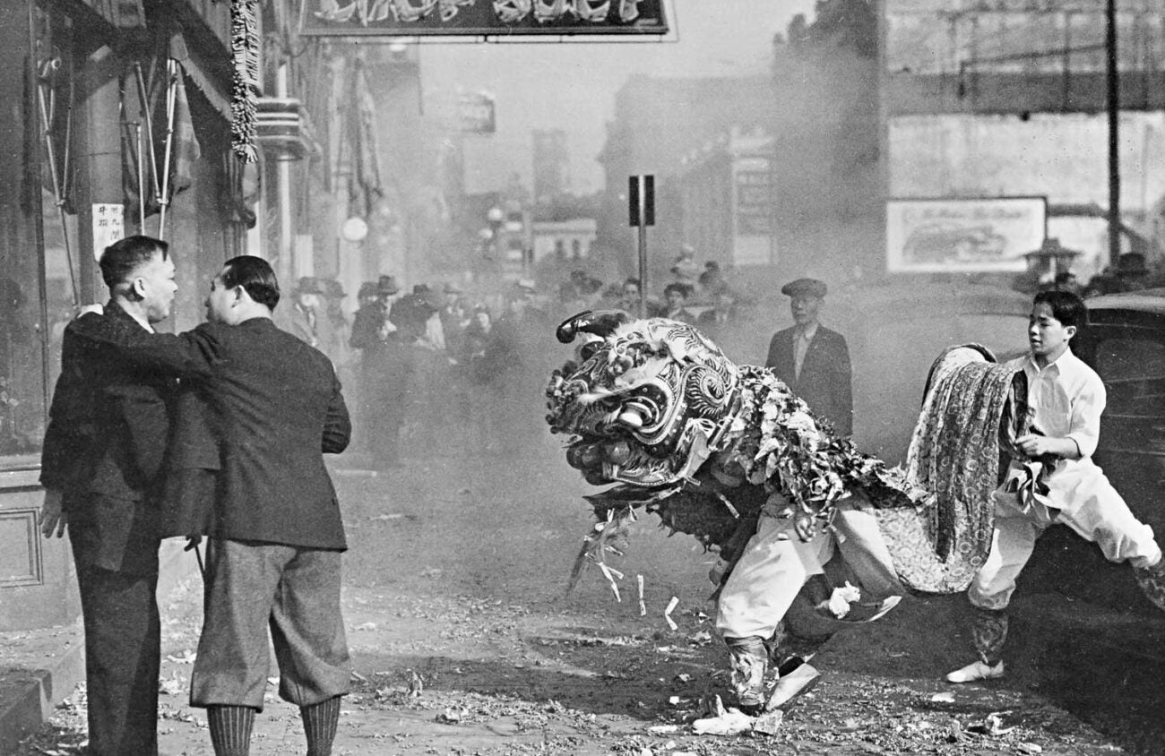 lion dancers on the street in black and white