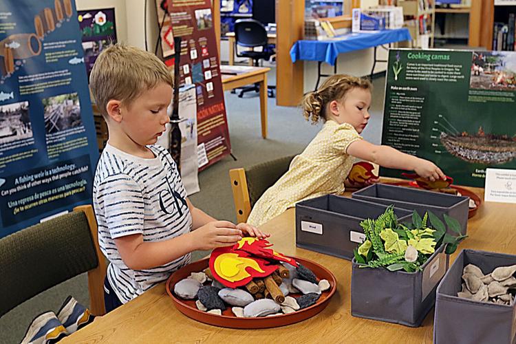 Kids making model earth ovens