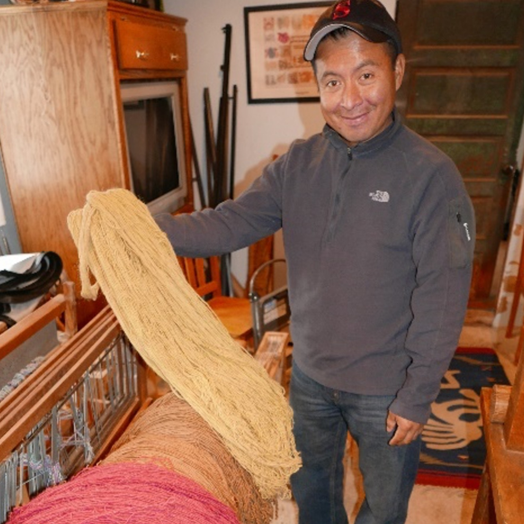 Francisco Bautista holding his weaving
