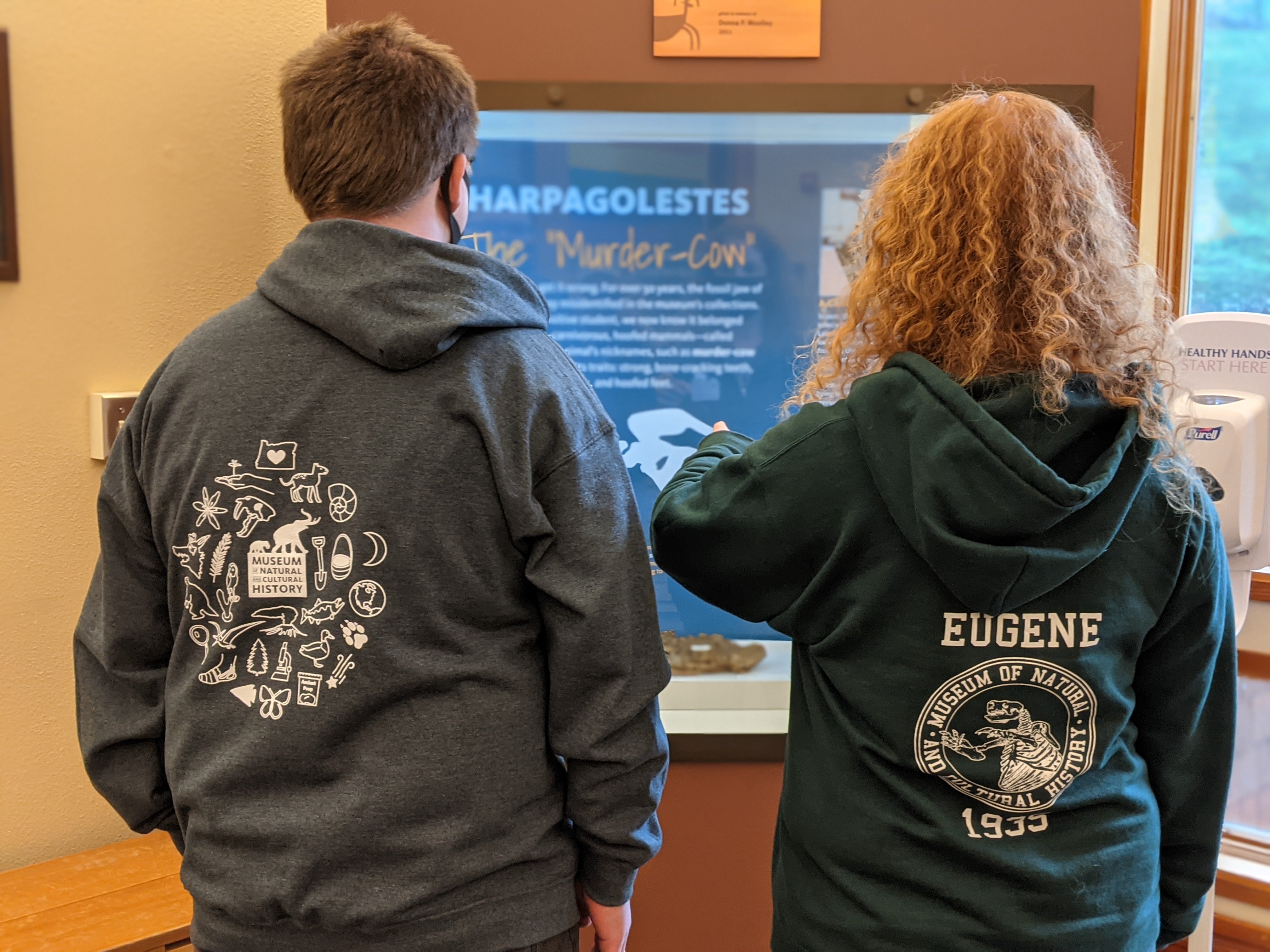 Two people wear museum-branded sweatshirts.jpg