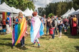 People wearing pride flags at festival
