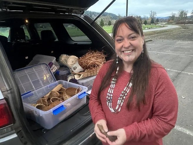 Stephanie Craig in front of her hand woven baskets