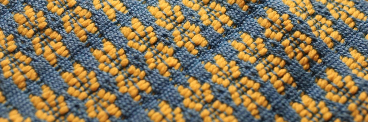 Woven textile with yellow stars on a blue background