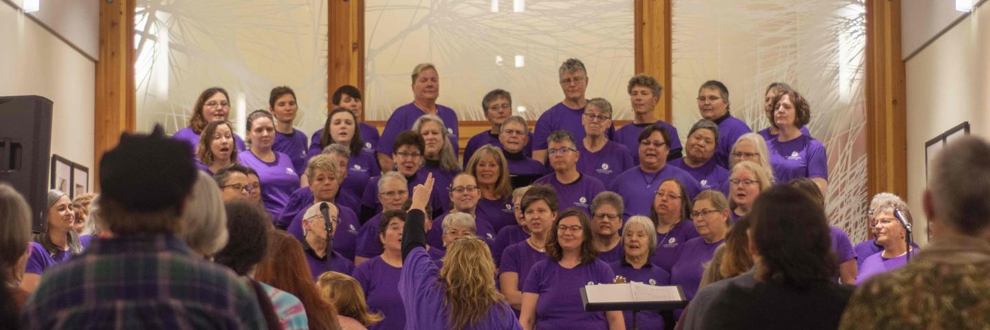 A chorus of lesbians sings in the museum's galleria space.