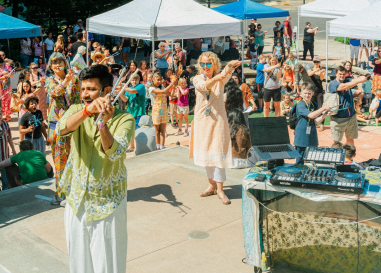 people outside with a musician