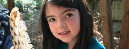 A child holding a raptor feather