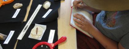 Kid investigating and recording scientific observations