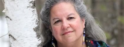 Woman standing next to a tree outside during winter