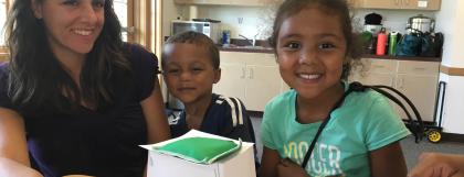 Two kids an an adult build a shelter