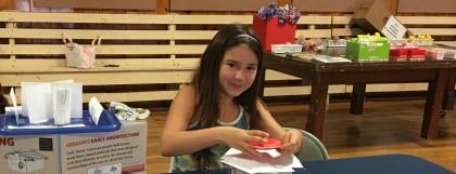 Child creating a shelter as part of the Engineer It! program