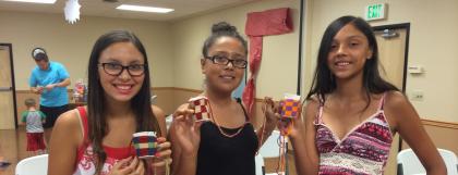 Participants showing their completed basketry crafts