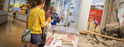 A volunteer talks with visitors in the museum