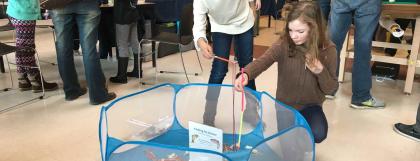 Two kids interact with the fishing activity