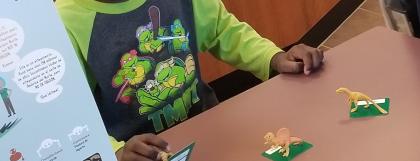 Child using Dino-story figures