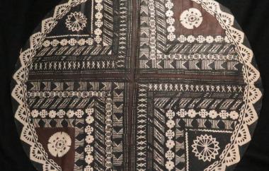 Circular tapa cloth with cross motif and lacy edge