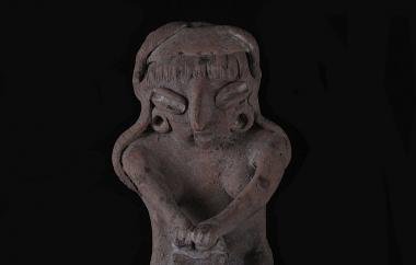 Female Human Figurine Kneeling to Grind Maize in Metate (front). Crafted to be three dimensional, this figurine is fully modeled front and rear. Buff earthenware, unpolished, traces of white paint.