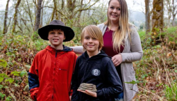 Oregon boy and family posing with mammoth tooth