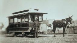 Historic photo of black man posing with streetcar