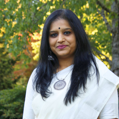 headshot of Smitha, an Indian woman wearing a white sari