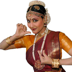 Jayanthi Raman posing in red and orange traditional clothing