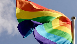 Pride flag against a blue sky, courtesy of Pixabay