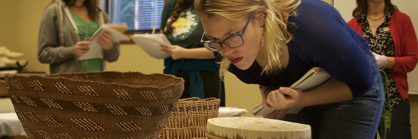 UO students examine a Native American basketry collection  