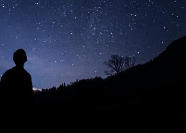 Silhouette of a child looking up at the stars