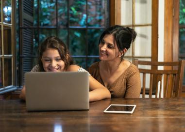 Mom and daughter at a laptop