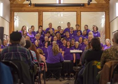 A chorus of lesbians sings in the museum's galleria space.