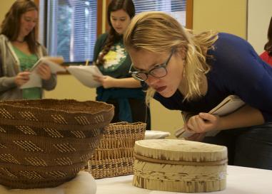 UO students examine a Native American basketry collection  