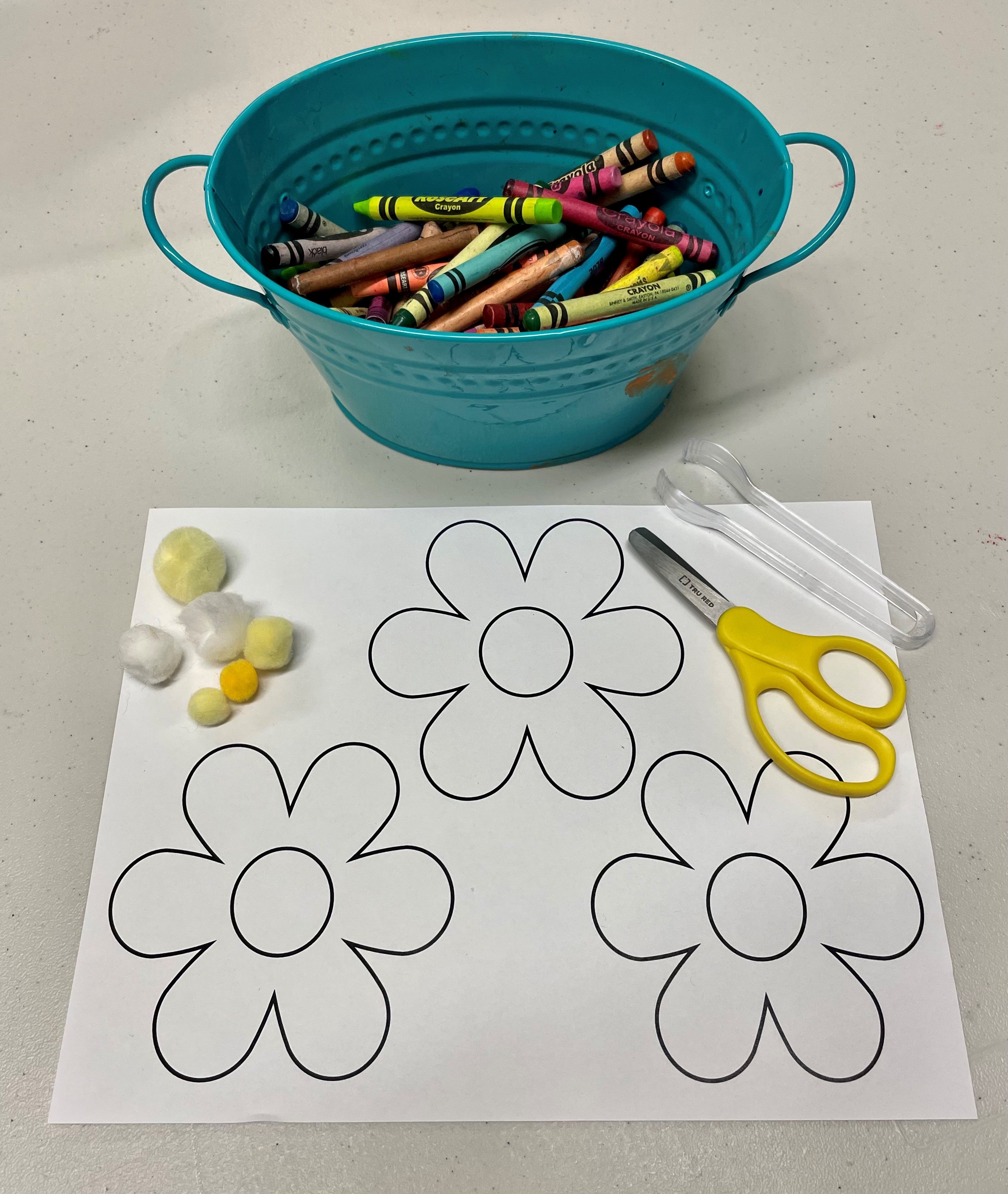 The Be a Bee activity, showing a flower template and a green bowl full of colorful crayons