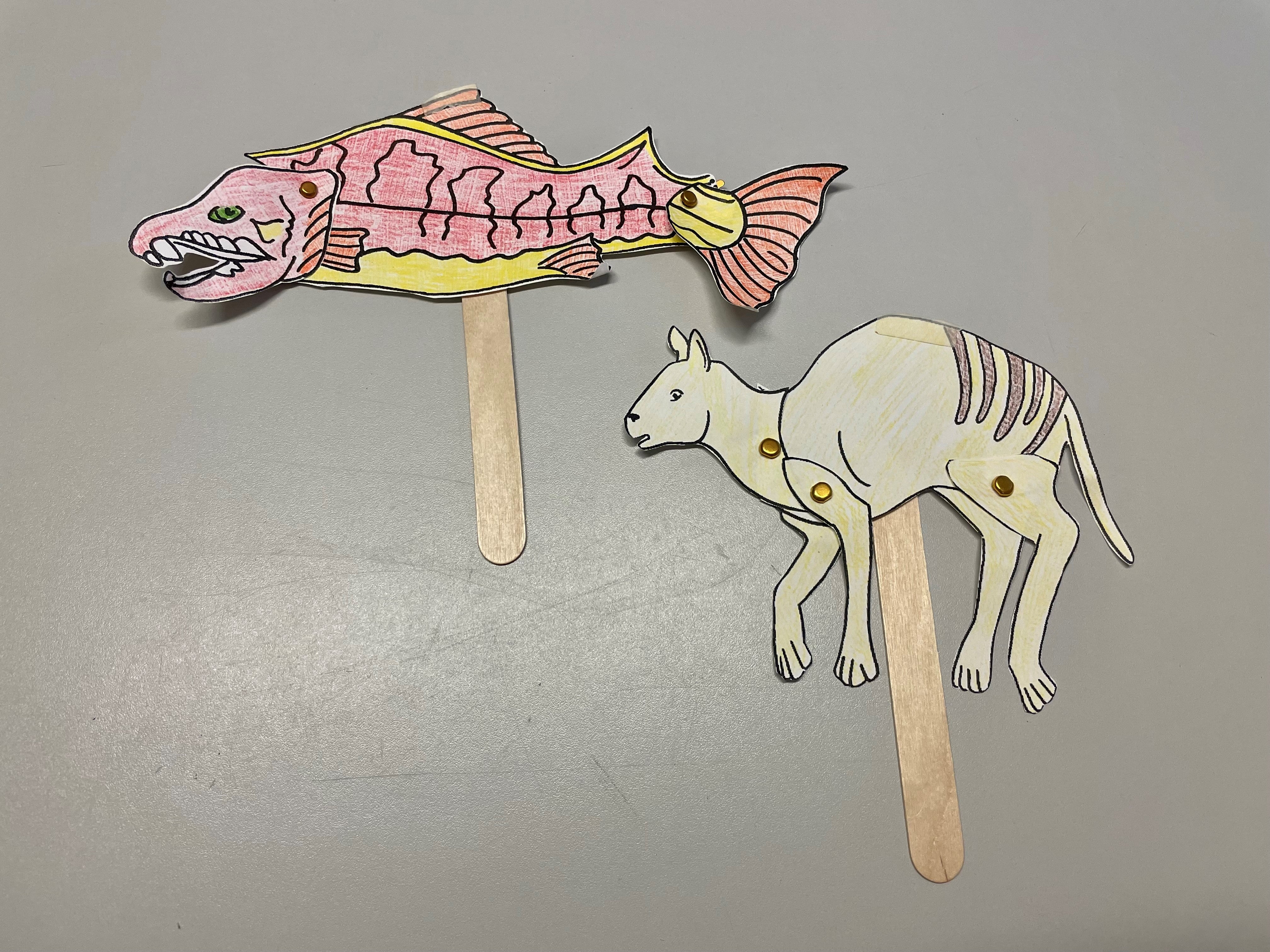 Prehistoric animal cutouts on popsicle sticks