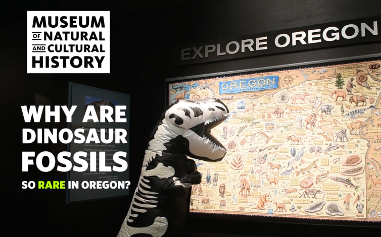 A person in a dinosaur costume looking at a map of Oregon at the museum